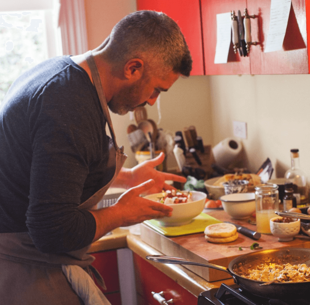 Chef preparing dish on kitchen counter.